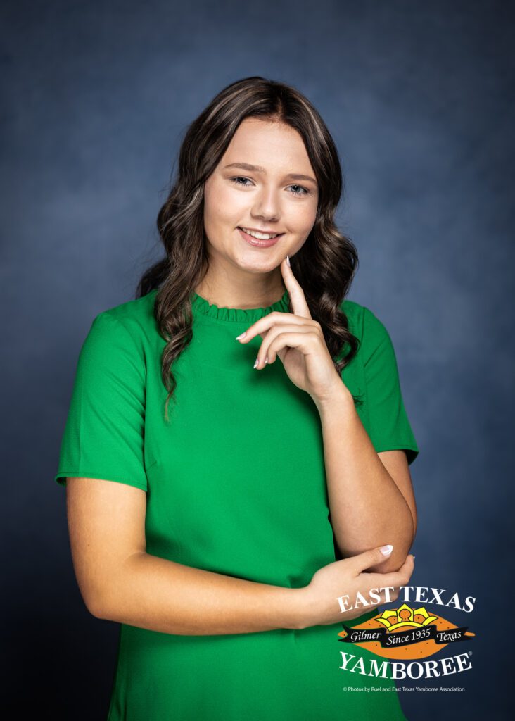 Smiling girl in green shirt for East Texas Jamboree.