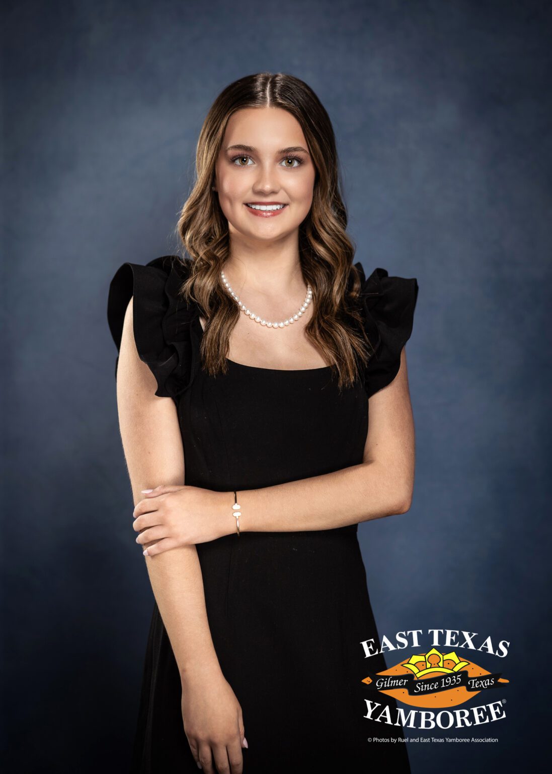 Young woman in black dress at a yamboree.