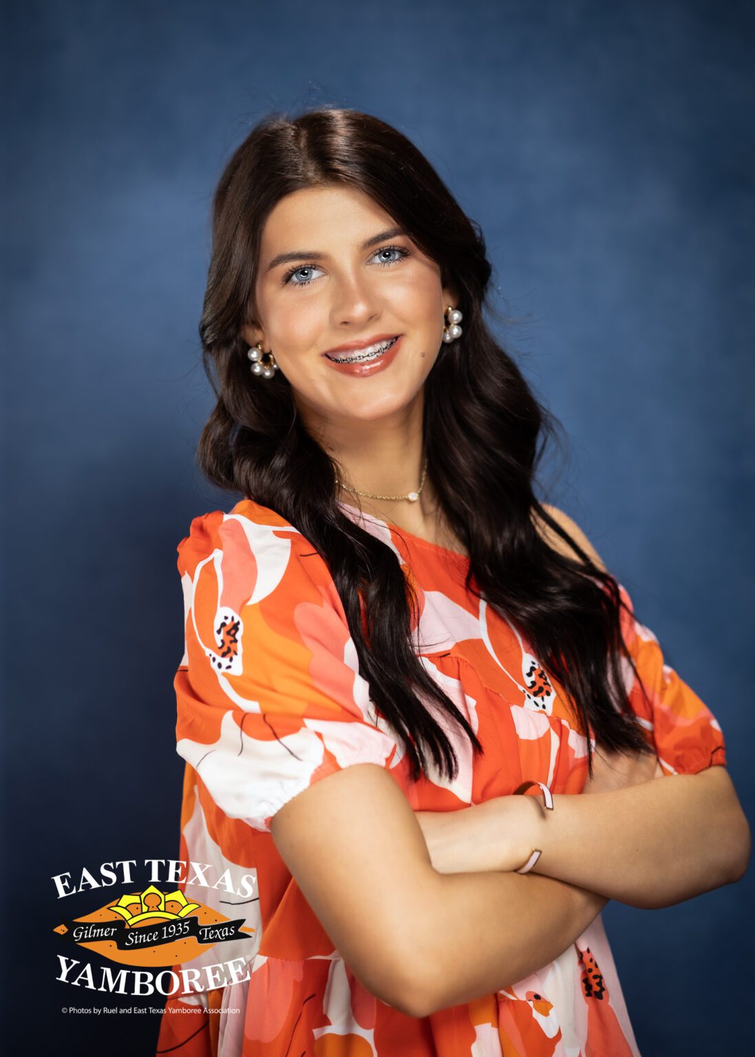 Smiling woman in floral dress at event.