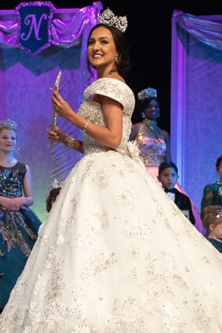 A girl wearing silver designer dress at the stage