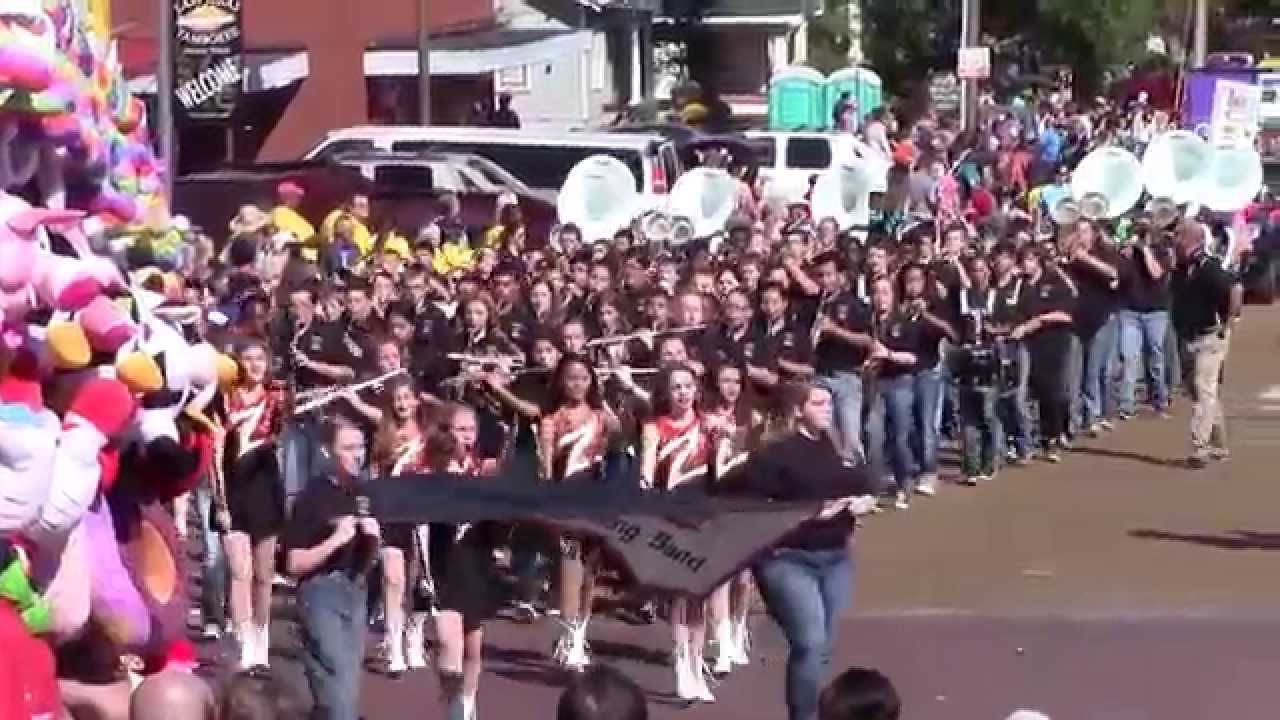 A large group of people marching down the street with teddy bears.